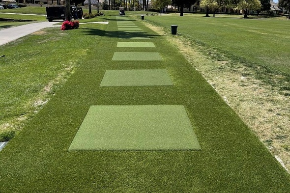 Greenwich Outdoor tee line with light green synthetic grass boxes inside a dark green synthetic grass strip